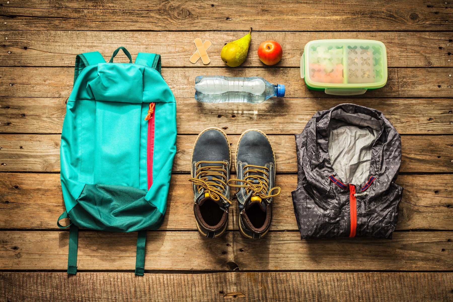 Summer hiking gear on a wooden backdrop
