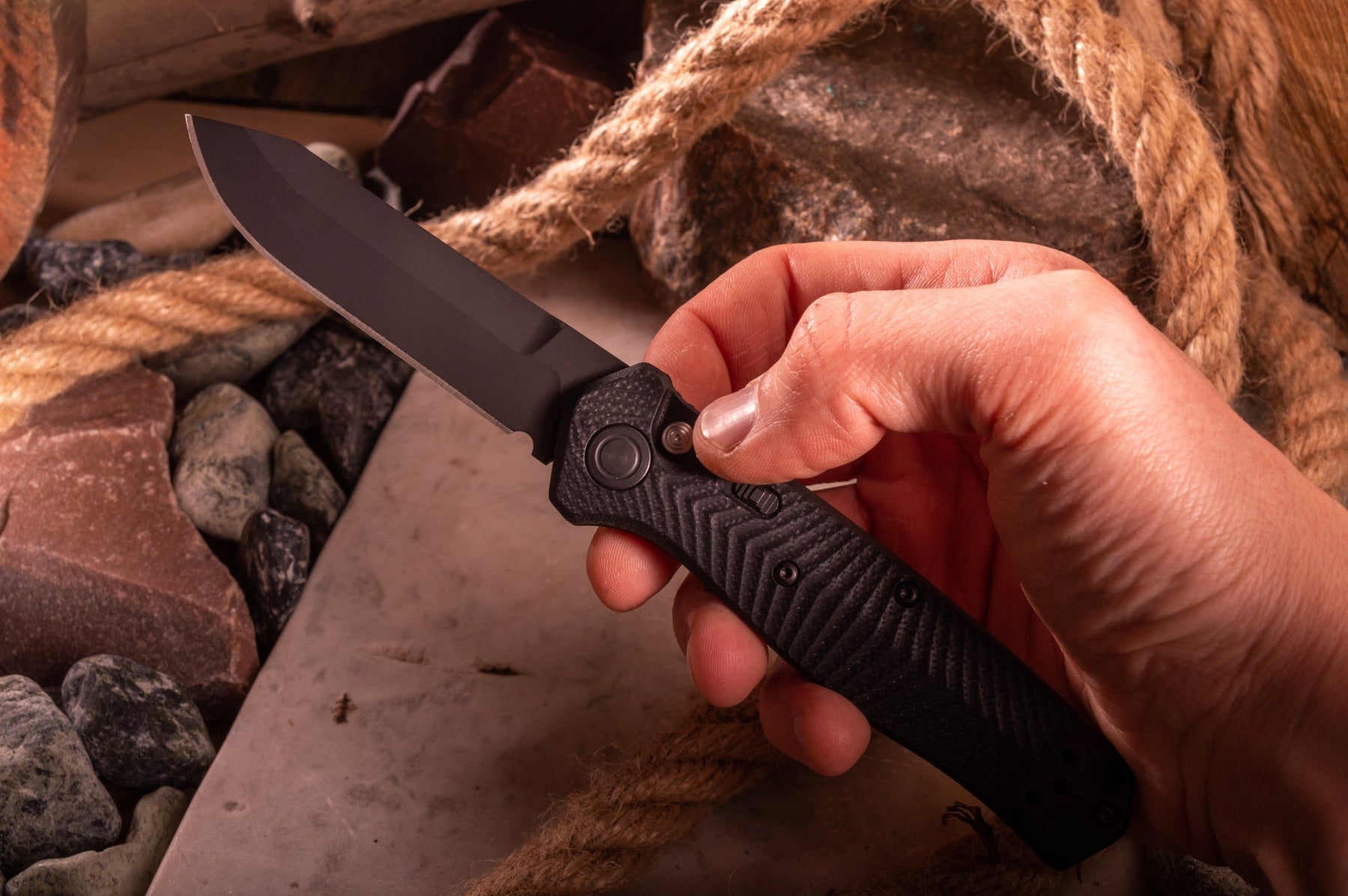A man’s hand holding a Benchmade EDC knife