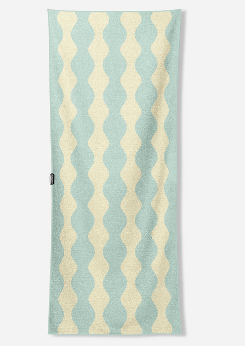 A rectangular towel with a vertical wavy stripe pattern in light blue and cream, shown flat against a light gray background.