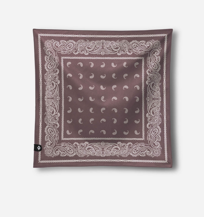 A square bandana scarf in a dusty mauve-brown color, featuring a white paisley border and a central grid of small white crescent moon and star motifs. A small black brand tag is visible on the bottom-left corner, set against a clean light gray background.