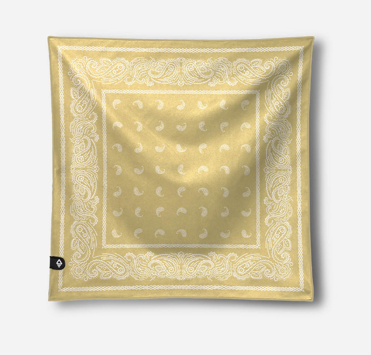 A square bandana scarf in pale yellow-gold with a white paisley border and white crescent moon motifs in the center, shown flat against a light gray background.