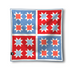 A square throw blanket featuring a four-quadrant geometric pattern in red, light blue, and white, with a small black brand tag on the bottom left corner, shown against a plain white background.