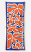 A rectangular beach towel with a bold pattern of orange stylized flowers outlined in cream on a royal blue background, shown flat against a light gray studio backdrop.